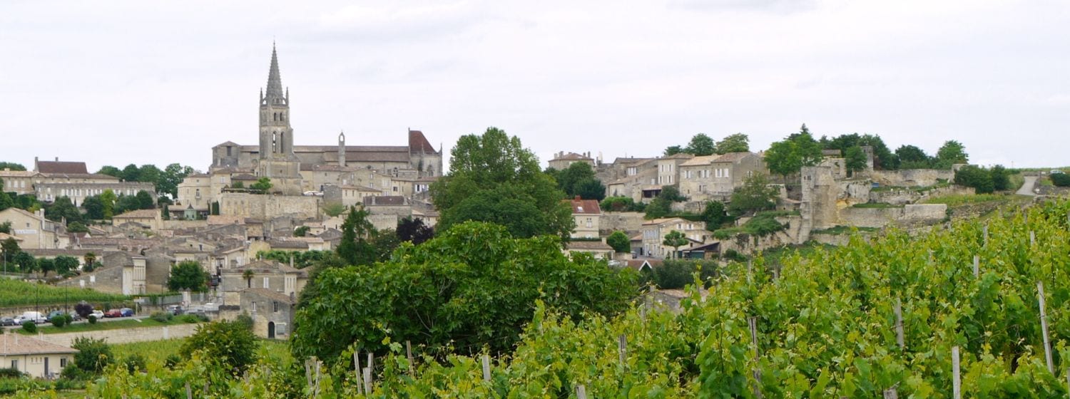 The medieval village of Saint-Émilion seen from above, with its vineyards rolling away behind the rooftops