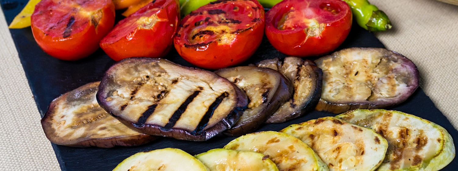 Charred vegetables on a grill