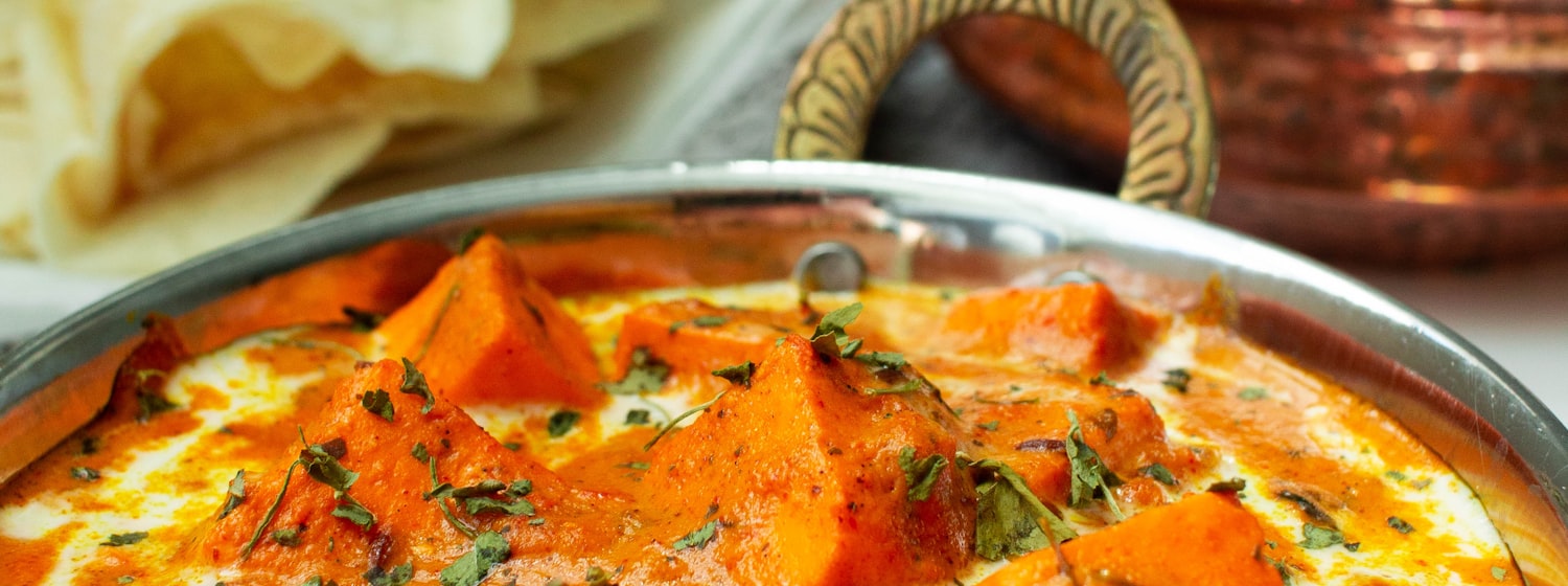 A bowl of creamy Indian butter chicken curry