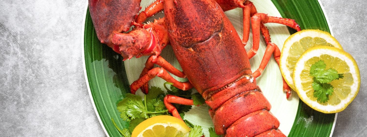 A plate of cooked lobster with lemon