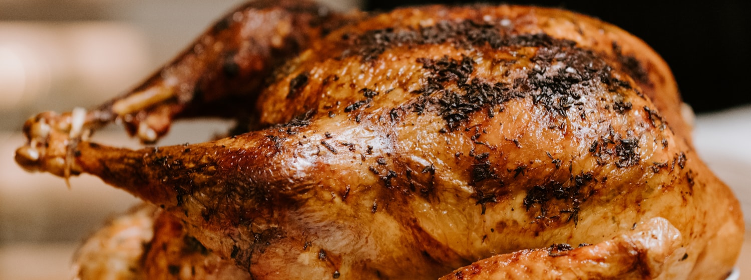 A whole roast chicken on a white plate
