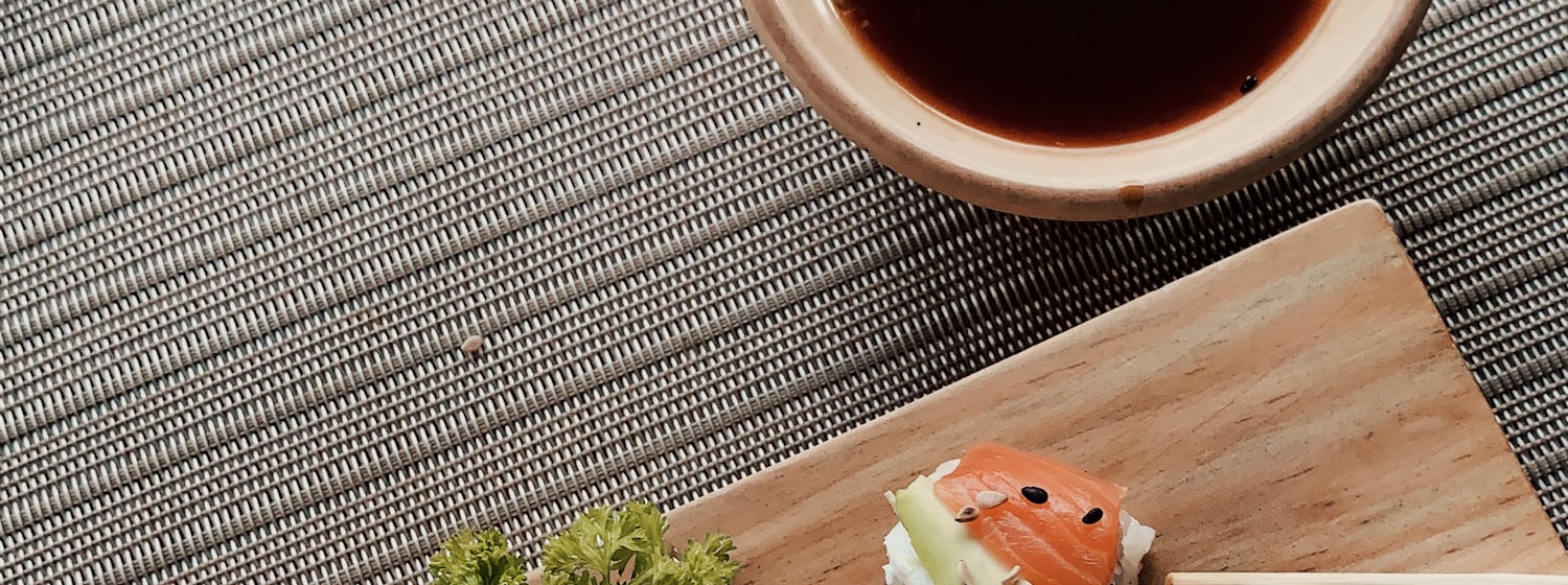 Salmon and avocado sushi rolls on a wooden board