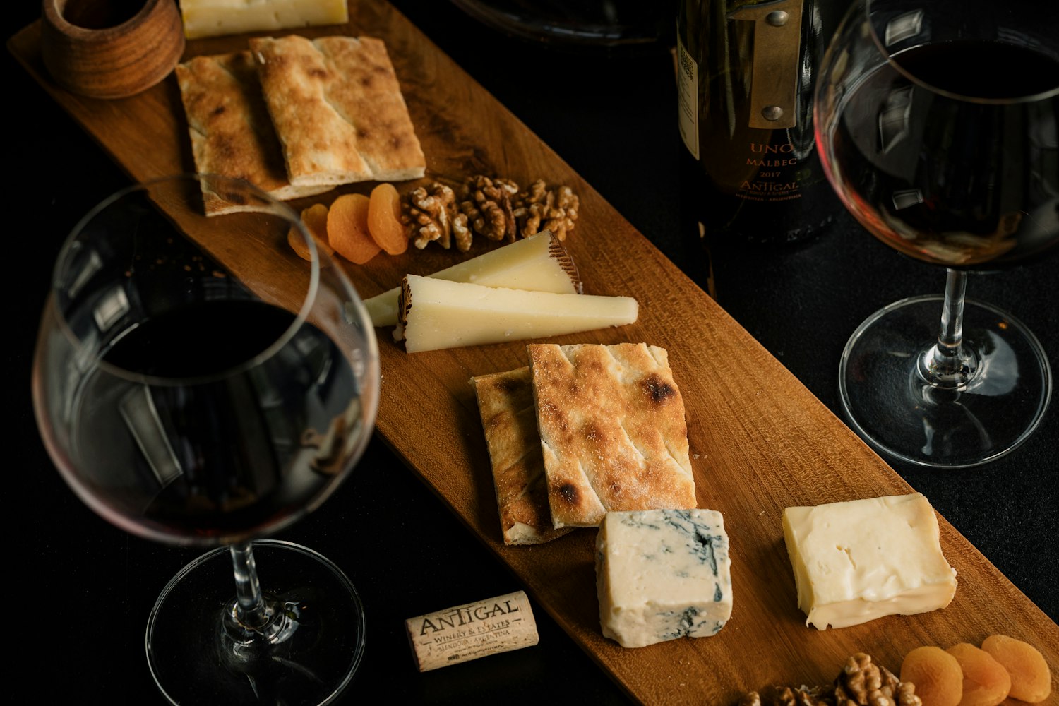 A wine and cheese board on a table