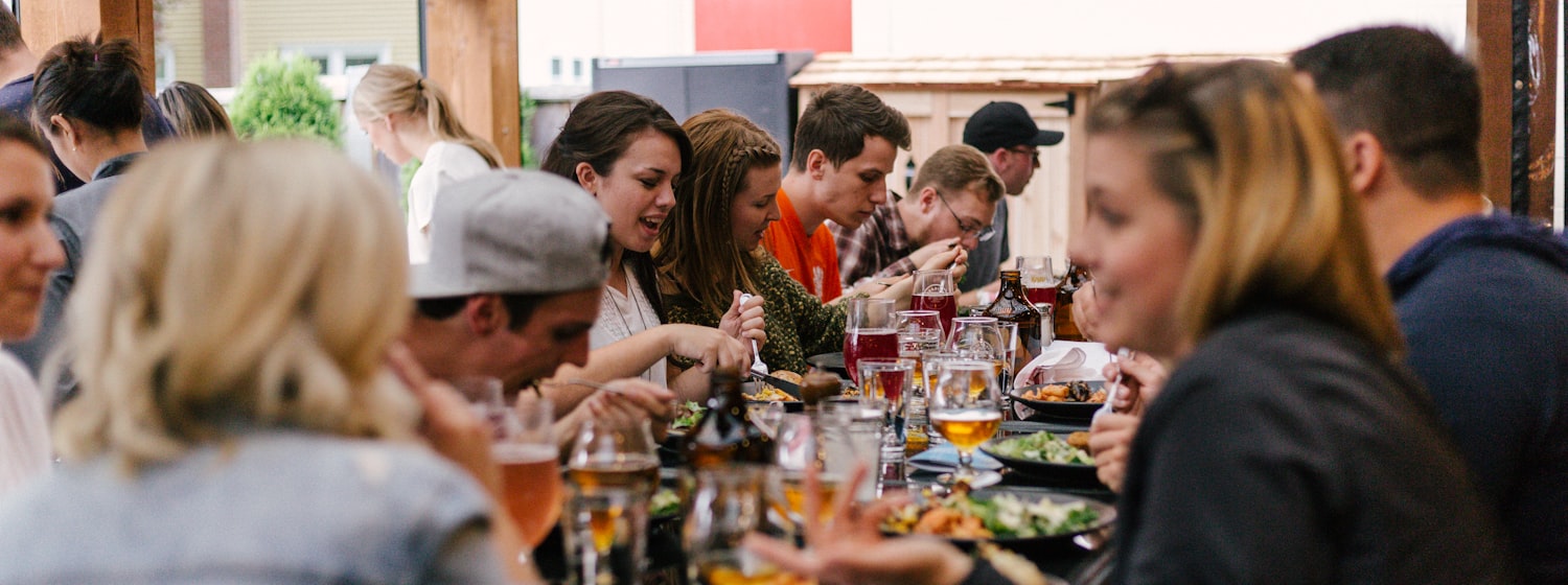 People sharing wine around a table